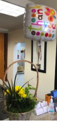 Photo of flowers and thank you balloon sent by client D. after winning disability case